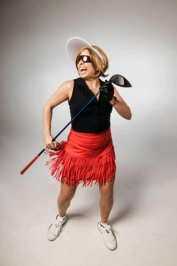 Comedian Becky Robinson in a red golf skirt holding a driver